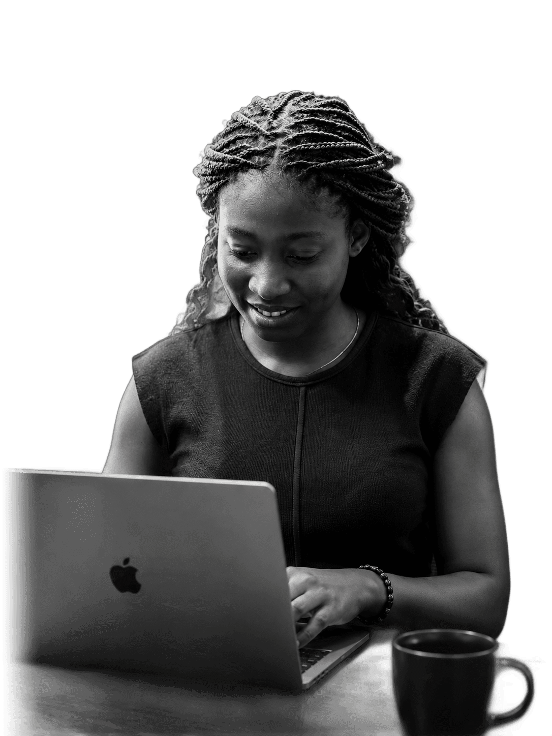 Etuk Godsgift working on a laptop
